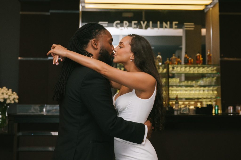 Couple kissing in front of Greyline bar